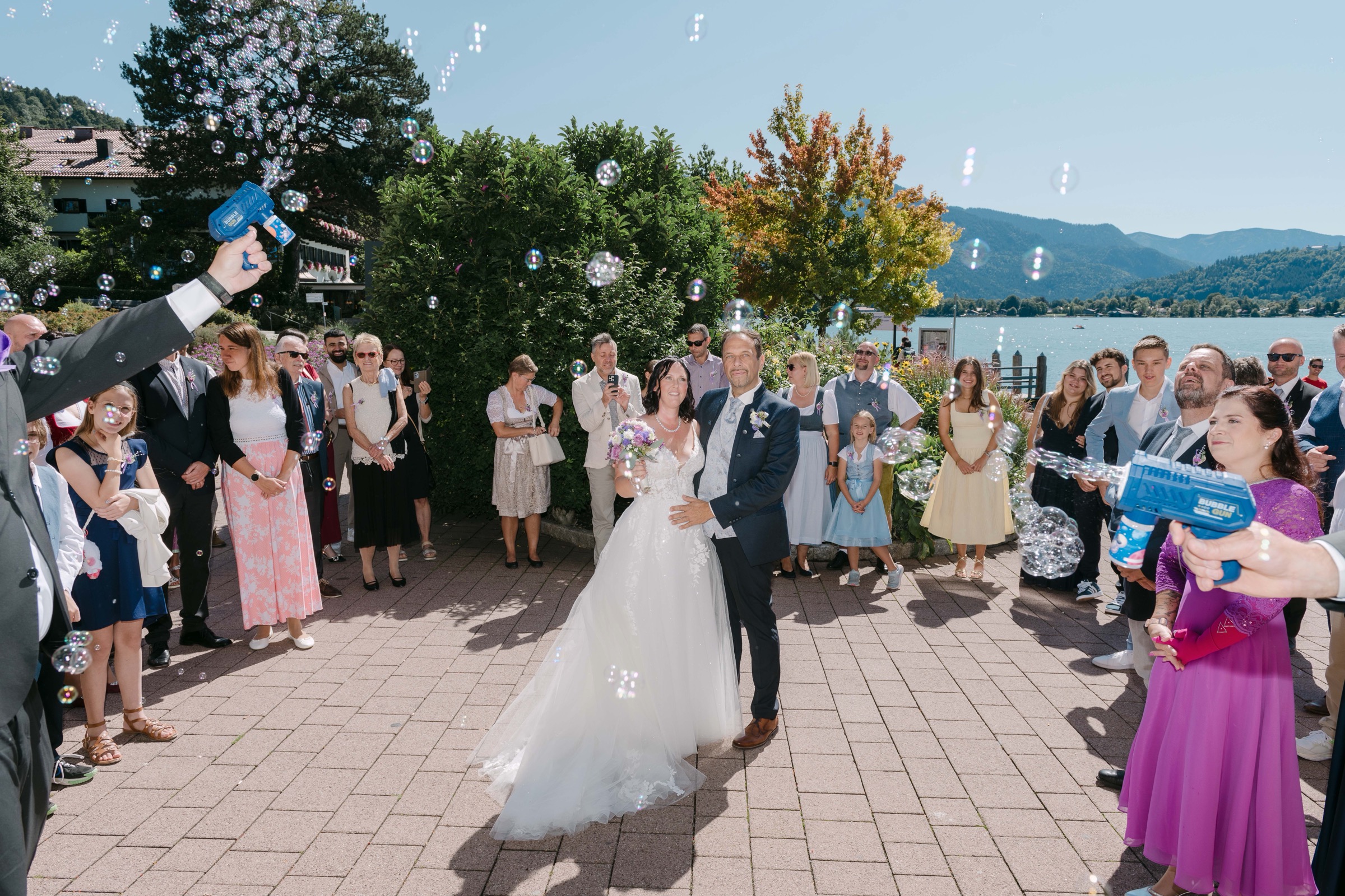 Joyful bubble exit at Lake Tegernsee wedding, Bavaria – Saphir Weddings